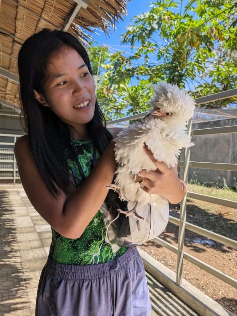 Feathery Fun, An Ostrich Park Adventure on Siquijor Island 3 My Island expert holding a fancy chicken at the Ostrich Park Siquijor